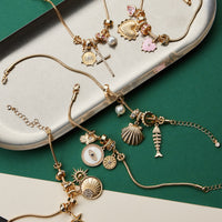 Gold Dipped Multi Charm Bracelet – Symbolic Pendant Collection