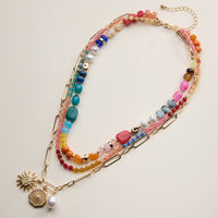 Layered Beaded and Chain Necklace with Sun and Pearl Charms – Gold Accent Design