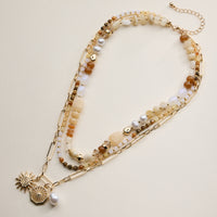 Layered Beaded and Chain Necklace with Sun and Pearl Charms – Gold Accent Design