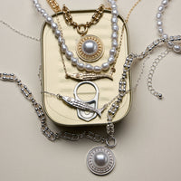 Layered Pearl and Chain Necklace with Round Pendant – Fish Link Detail