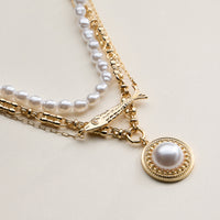 Layered Pearl and Chain Necklace with Round Pendant – Fish Link Detail