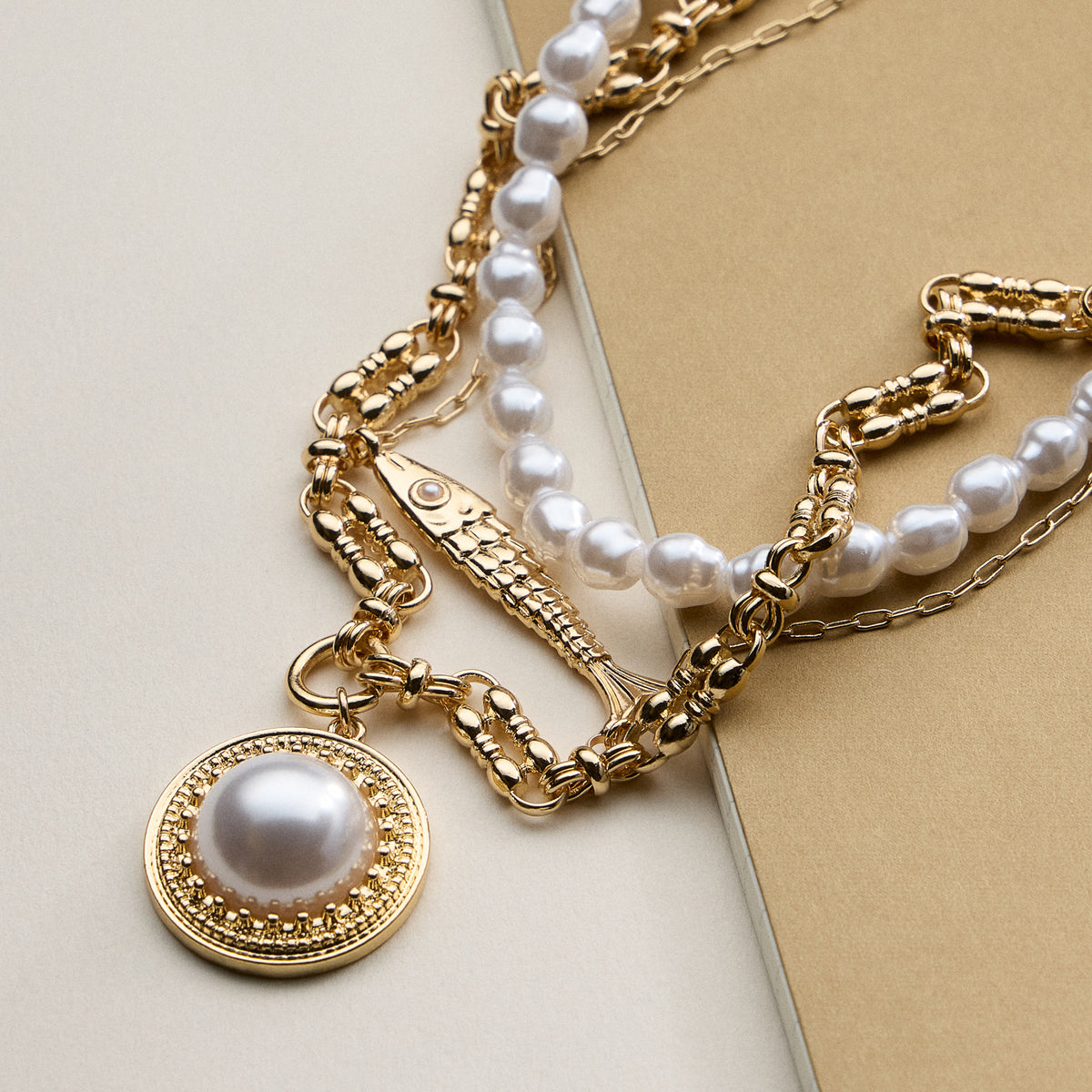 Layered Pearl and Chain Necklace with Round Pendant – Fish Link Detail
