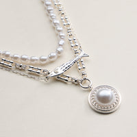 Layered Pearl and Chain Necklace with Round Pendant – Fish Link Detail
