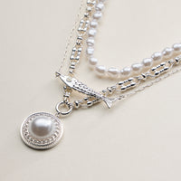 Layered Pearl and Chain Necklace with Round Pendant – Fish Link Detail