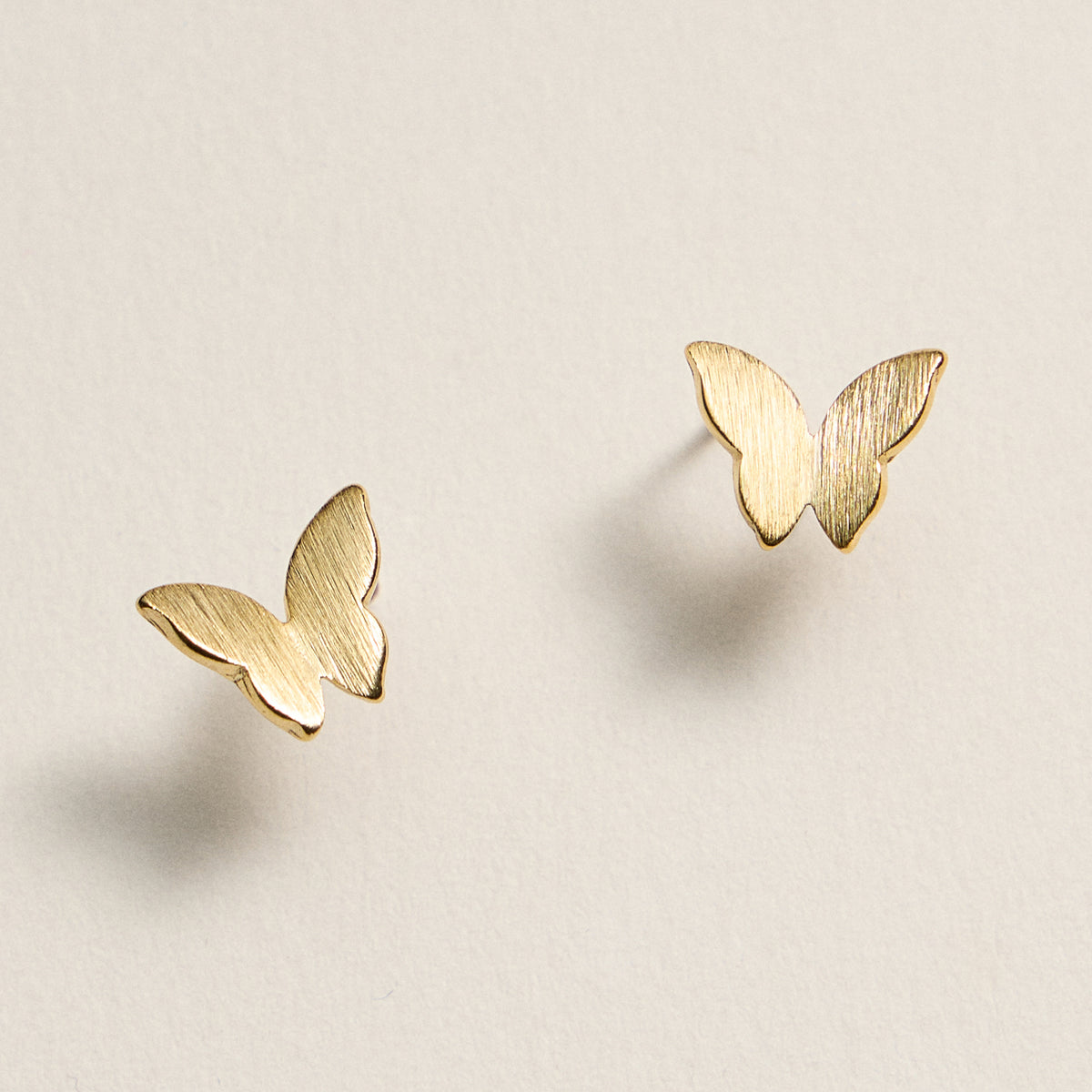 Gold Dipped Butterfly Stud Earrings – Minimalist Brushed Metal Design