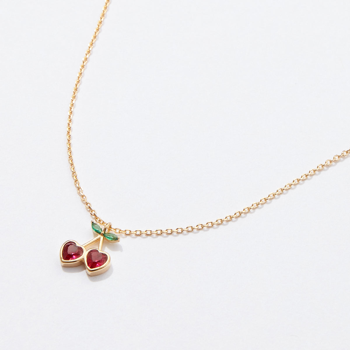 Gold Cherry Necklace with Heart-Shaped Red Stones & Green Leaf Accents – Dainty & Elegant Jewelry